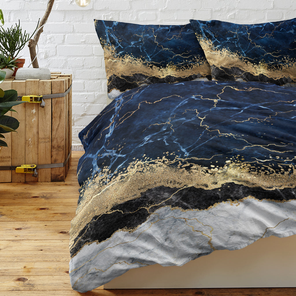 Chic white marble bed linen with gold accents.